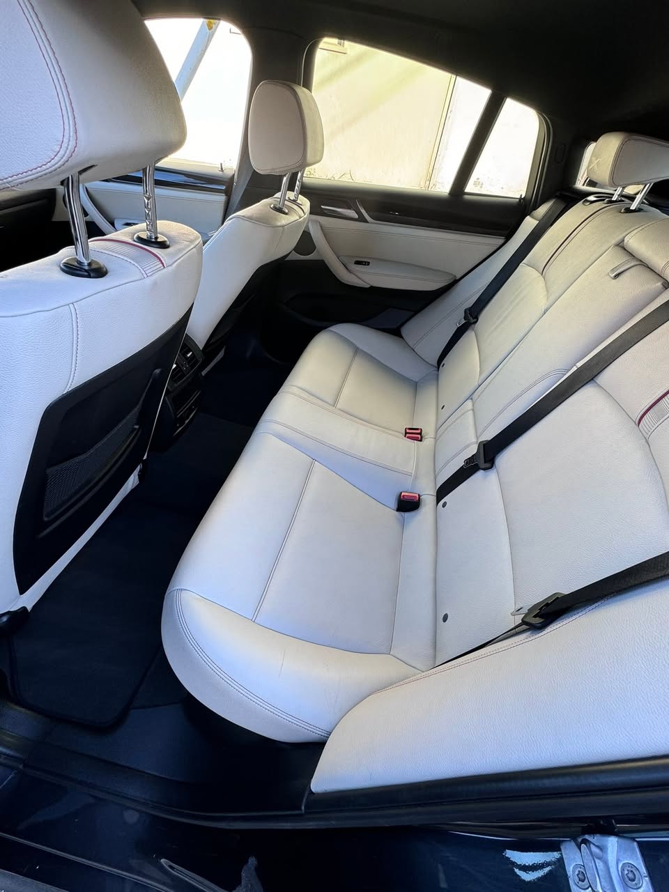 White leather rear seats deep cleaned during mobile interior detailing in San Francisco